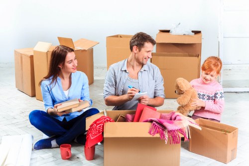 Removal team planning a house move in Acton with boxes and furniture
