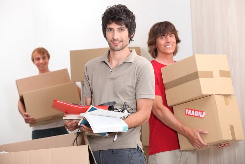Furniture and boxes being unloaded during a home move in Acton