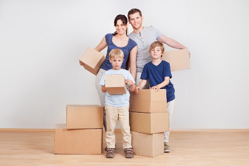Loading household items into a van for a local move in Acton