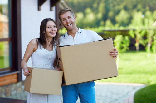Professional movers handling furniture in a flat with tight access in Acton