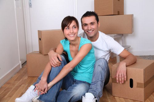 Local moving team preparing furniture and packed items for transport in Acton