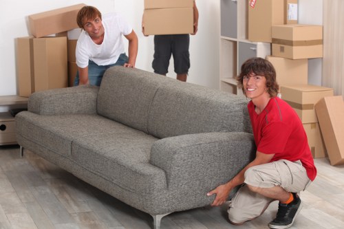 Furniture and boxes being loaded into a moving truck in Acton